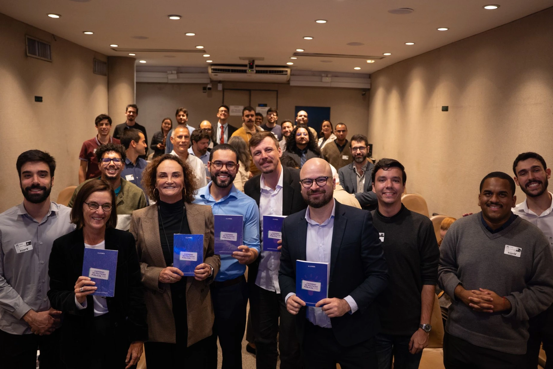 Público segurando Caderno de Políticas Públicas ao fim do evento de lançamento no Rio de Janeiro